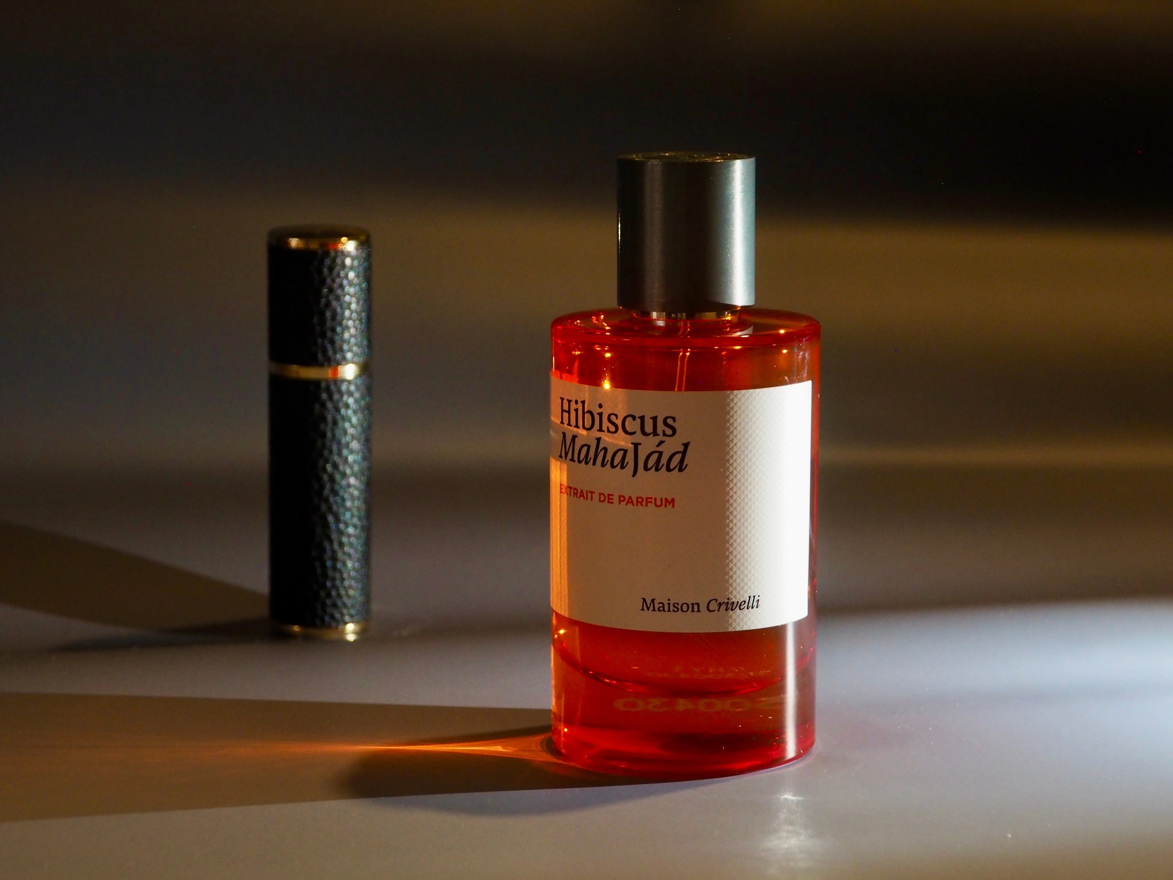 Flacons de parfum Maison Crivelli présentés sur une table élégante